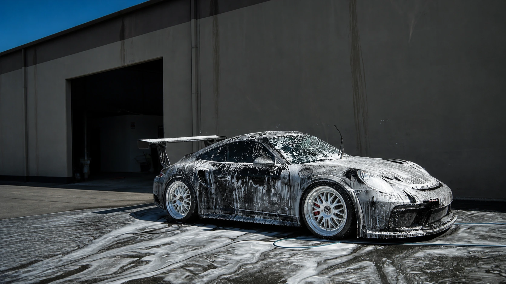 Foam-covered Porsche during a premium exterior detail